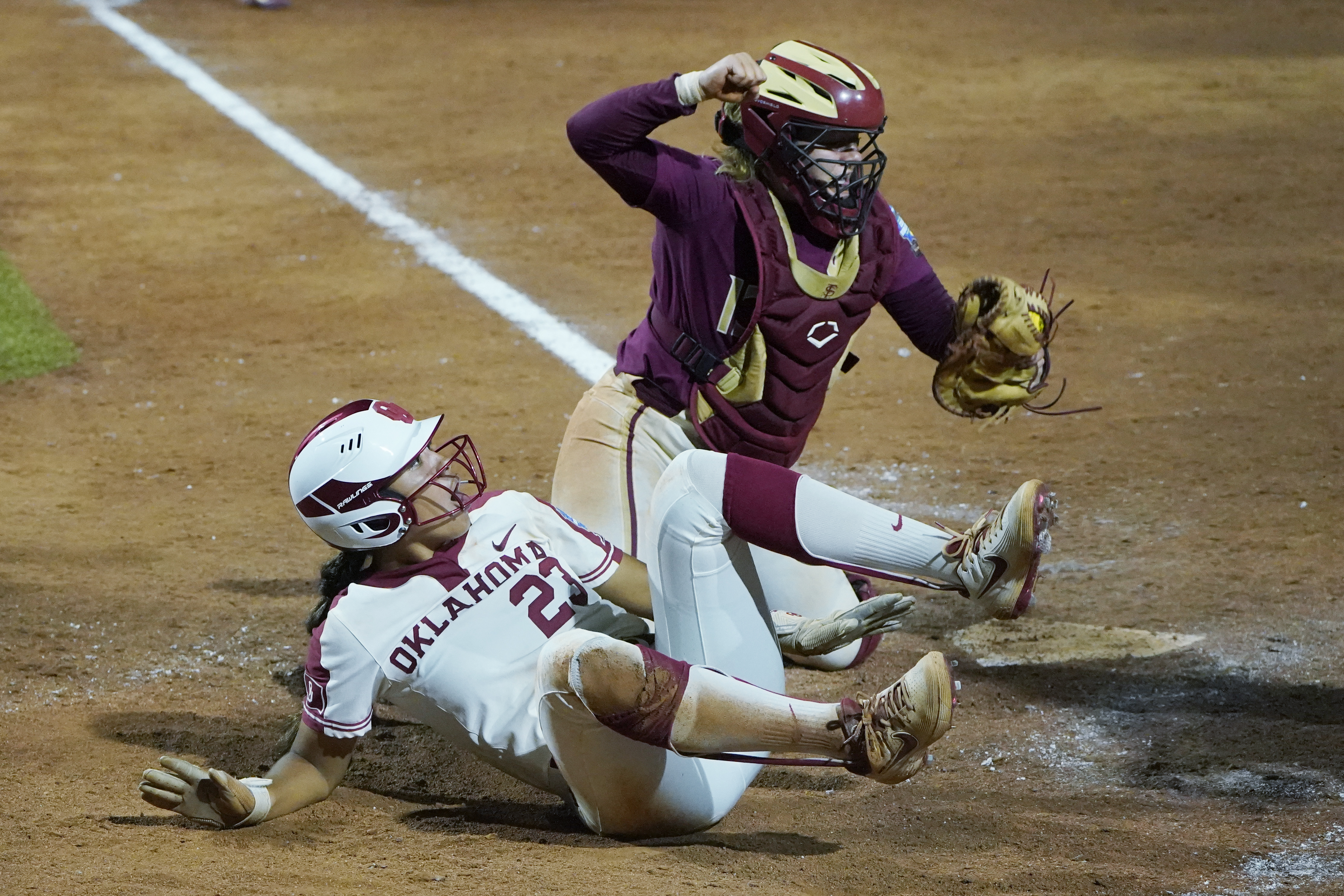 Florida State Seminoles catcher Anna Shelnutt tags out Oklahoma player Tiare Jennings in Women's College World Series, June 8, 2021