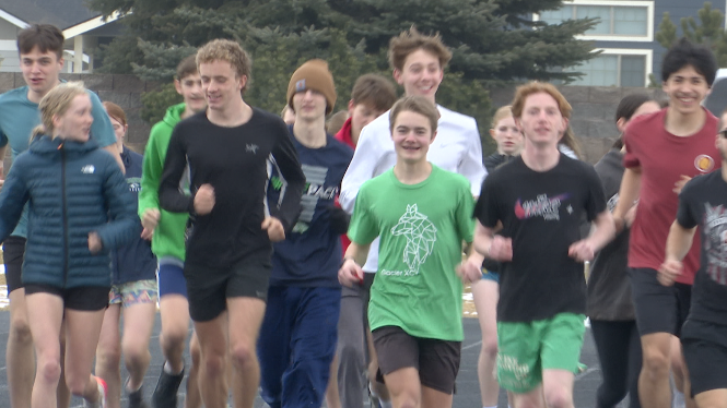 Asher Stanfield warming up with Glacier Track distance runners, March 18, 2026