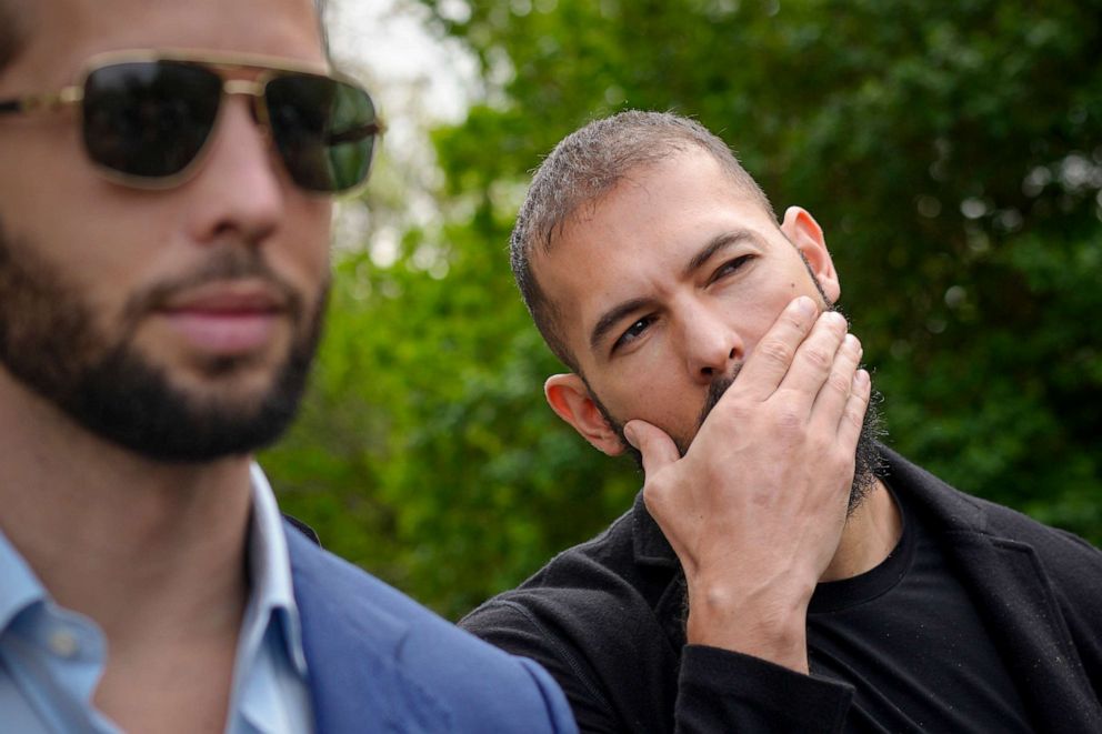 Andrew Tate, right, and his brother Tristan, left, leave the Bucharest Tribunal, in Bucharest, Romania, Friday, April 21, 2023.