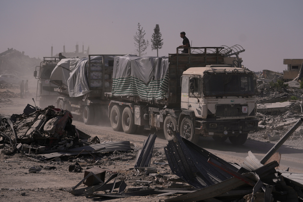 Trucks carrying humanitarian aid drive through Khan Younis, in the southern Gaza Strip.
