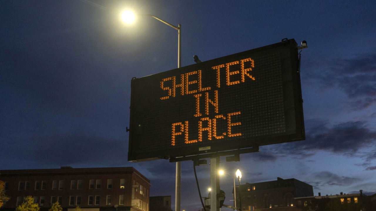 A sign advises residents to stay home.