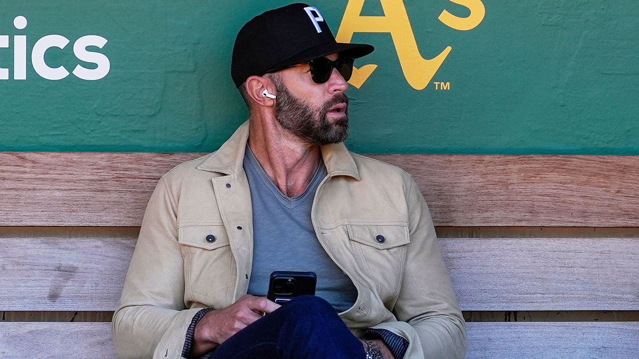 FILE - Miami Marlins assistant general manager Gabe Kapler sits in the dugout before the team's baseball game against the Oakland Athletics, May 3, 2024, in Oakland, Calif.  