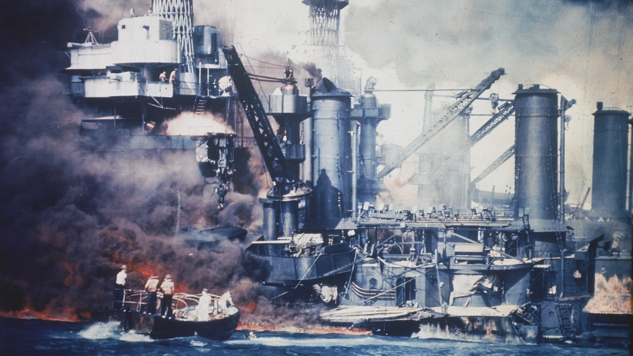 A small boat rescues a USS West Virginia crew member from the water after the Japanese bombing of Pearl Harbor, Hawaii, on Dec. 7, 1941..jpg