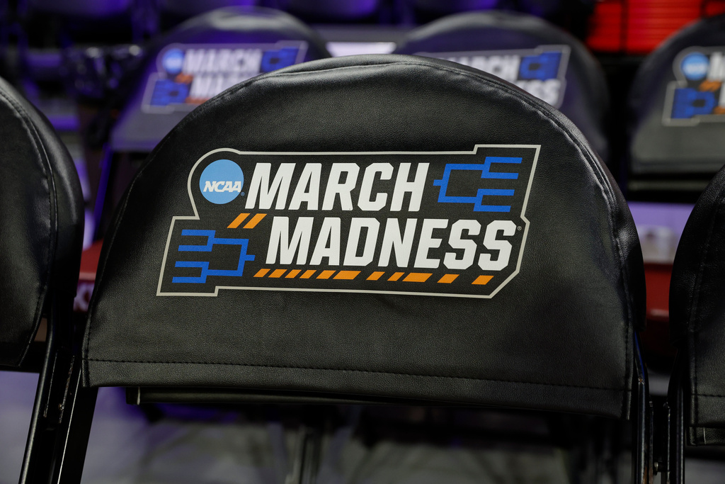 March Madness signage is displayed on chairs before a game between Colorado State and Michigan State in the first round of the NCAA college basketball tournament, Friday, March 20, 2026, Norman, Okla.