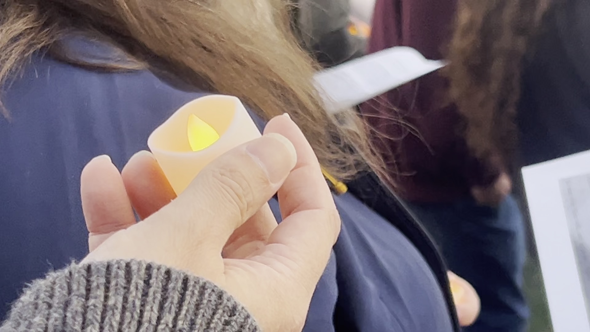 MSU Student holds candle during Oct 7 anniversary