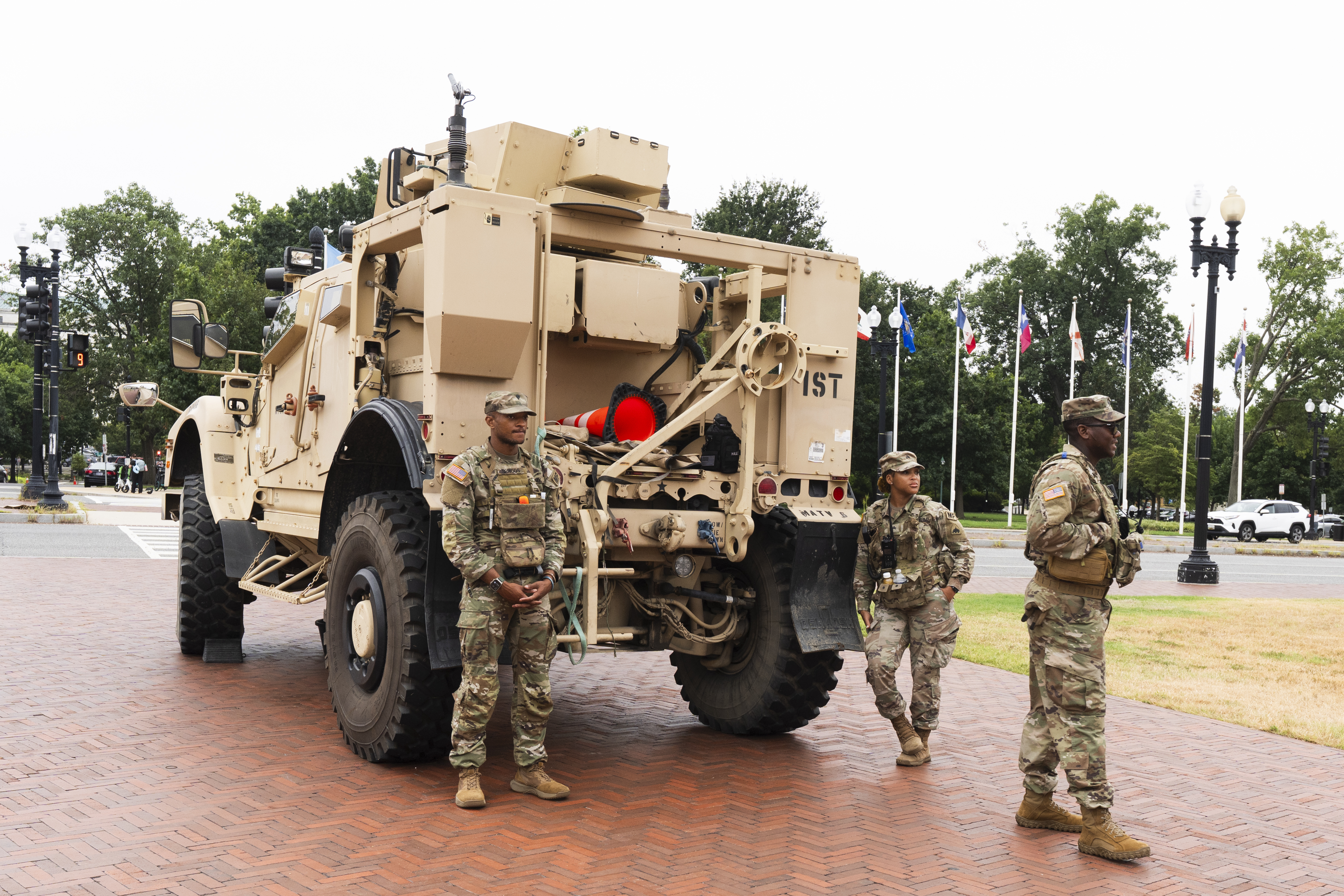 Members of the District of Columbia National Guard, stand next to an M-ATV infantry mobility vehicle, outside the Union Station in Washington, Monday, Aug. 18, 2025