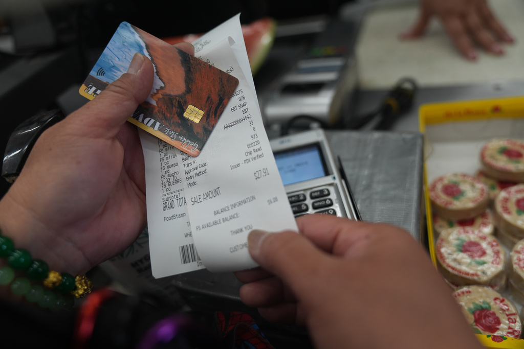 Jannette Victor checks her balance left after purchasing food supplies with a California EBT (Electronic Benefit Transfer) card in Los Angeles, Friday, Oct. 31, 2025. 