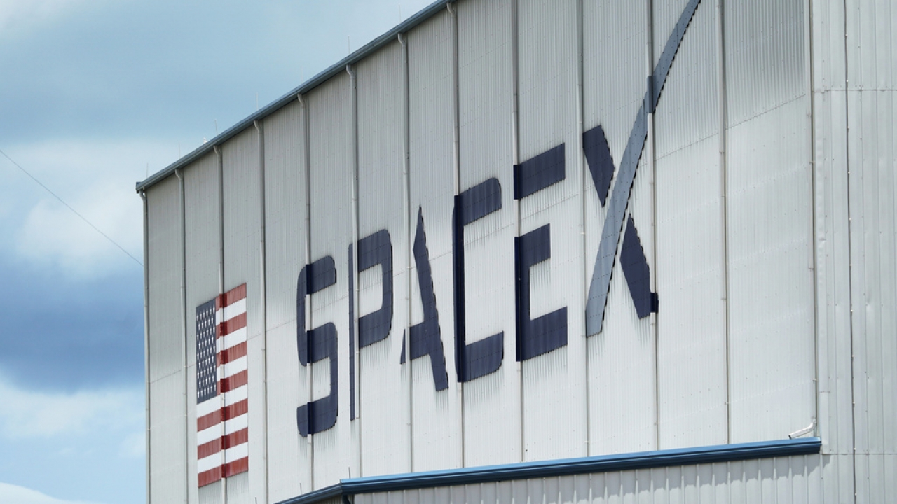 The SpaceX logo is displayed on a building.