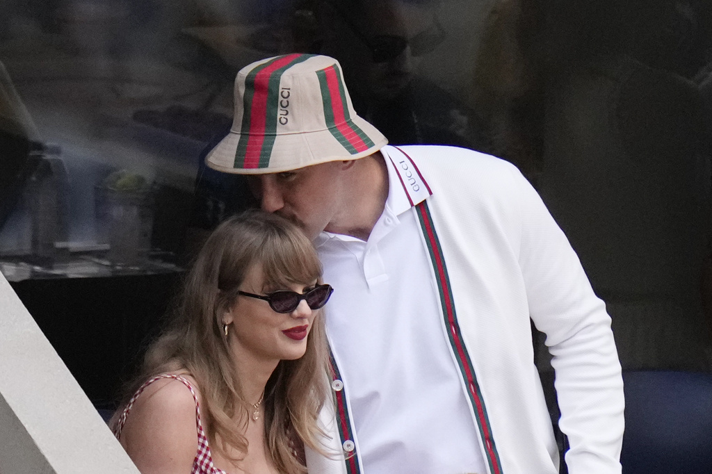 Taylor Swift gets a kiss from Kansas City Chiefs tight end Travis Kelce as they arrive to watch play between Jannik Sinner, of Italy, and Taylor Fritz, of the United States, during the men's singles final of the U.S. Open tennis championships.