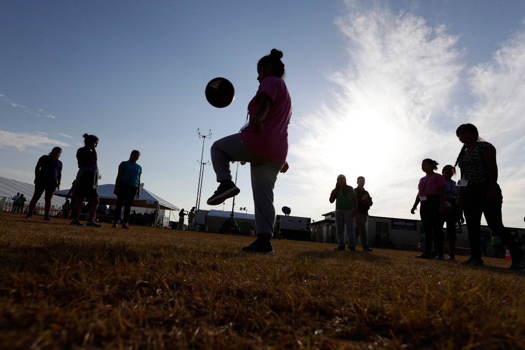Immigrants play soccer at a new U.S. government holding center for migrant children. 