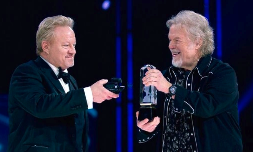 Randy Bachman holds Juno Award as Robbie Bachman videotapes in 2014