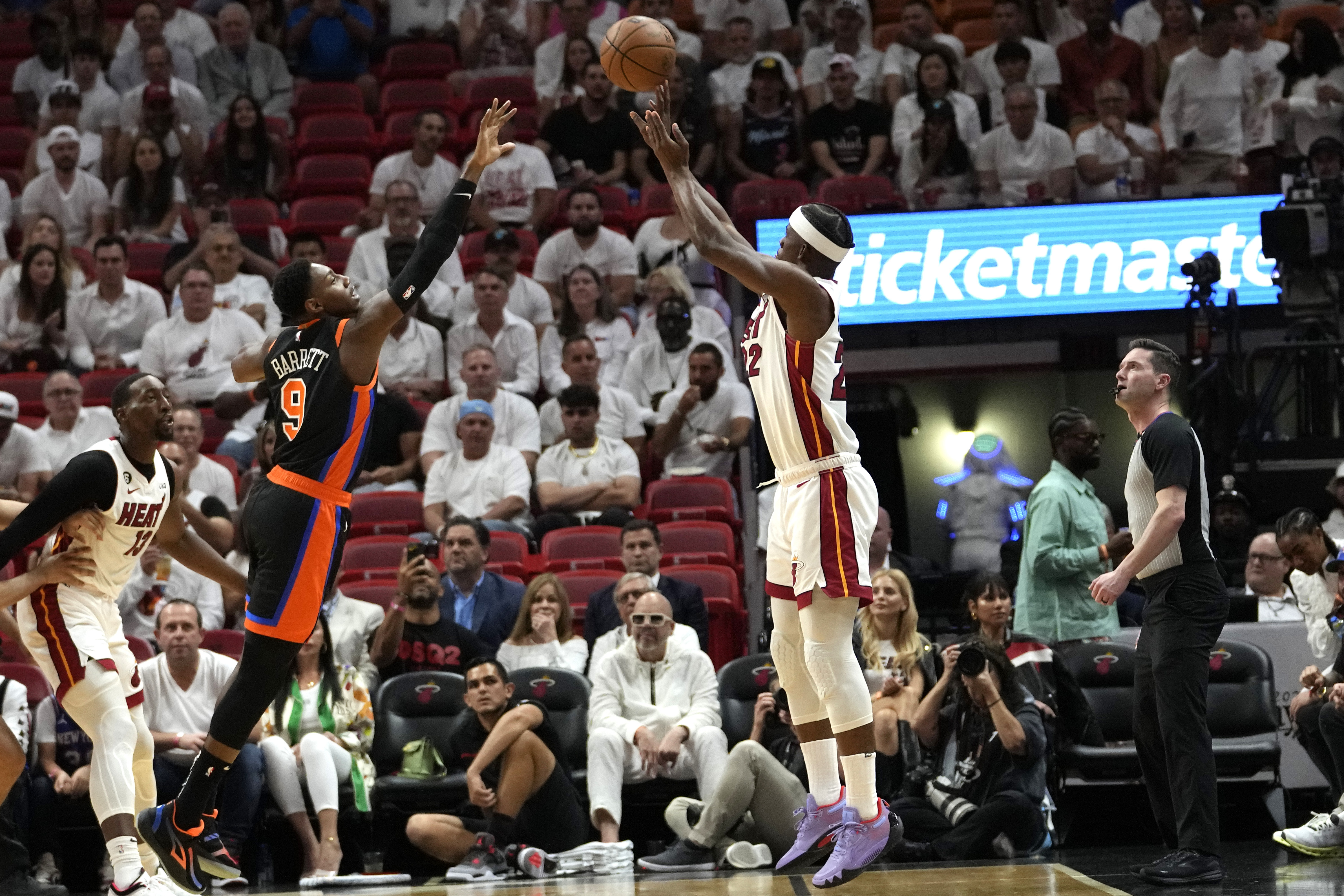 Miami Heat forward Jimmy Butler shoots 3-point shot as New York Knicks guard RJ Barrett defends in Game 4 of NBA second-round playoff series, May 8, 2023