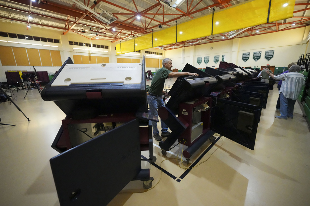 John Farnsworth sets up voting machines at the Hynes Charter School in New Orleans on Election Day, Tuesday, Nov. 5, 2024. 