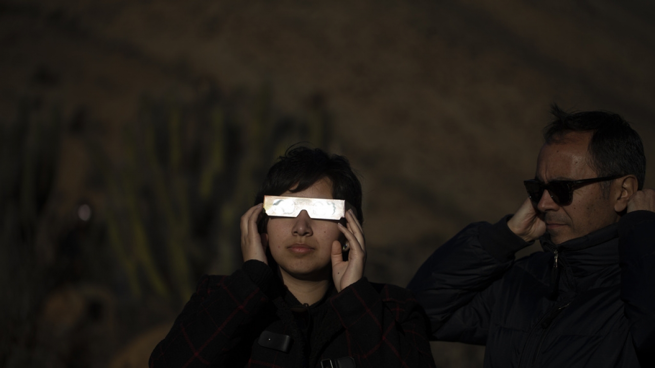 People watch a total solar eclipse.