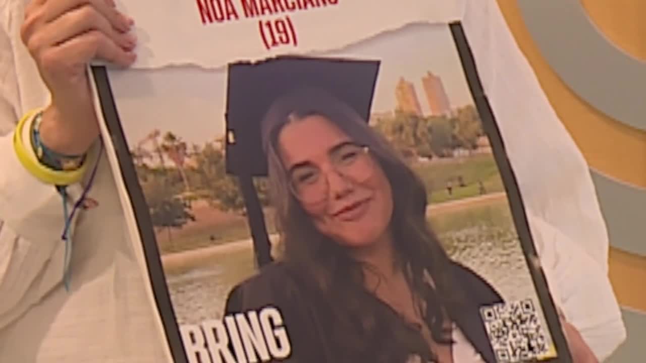 Adi Marciano holds poster of Noa Marciano, who disappeared during Hamas invasion