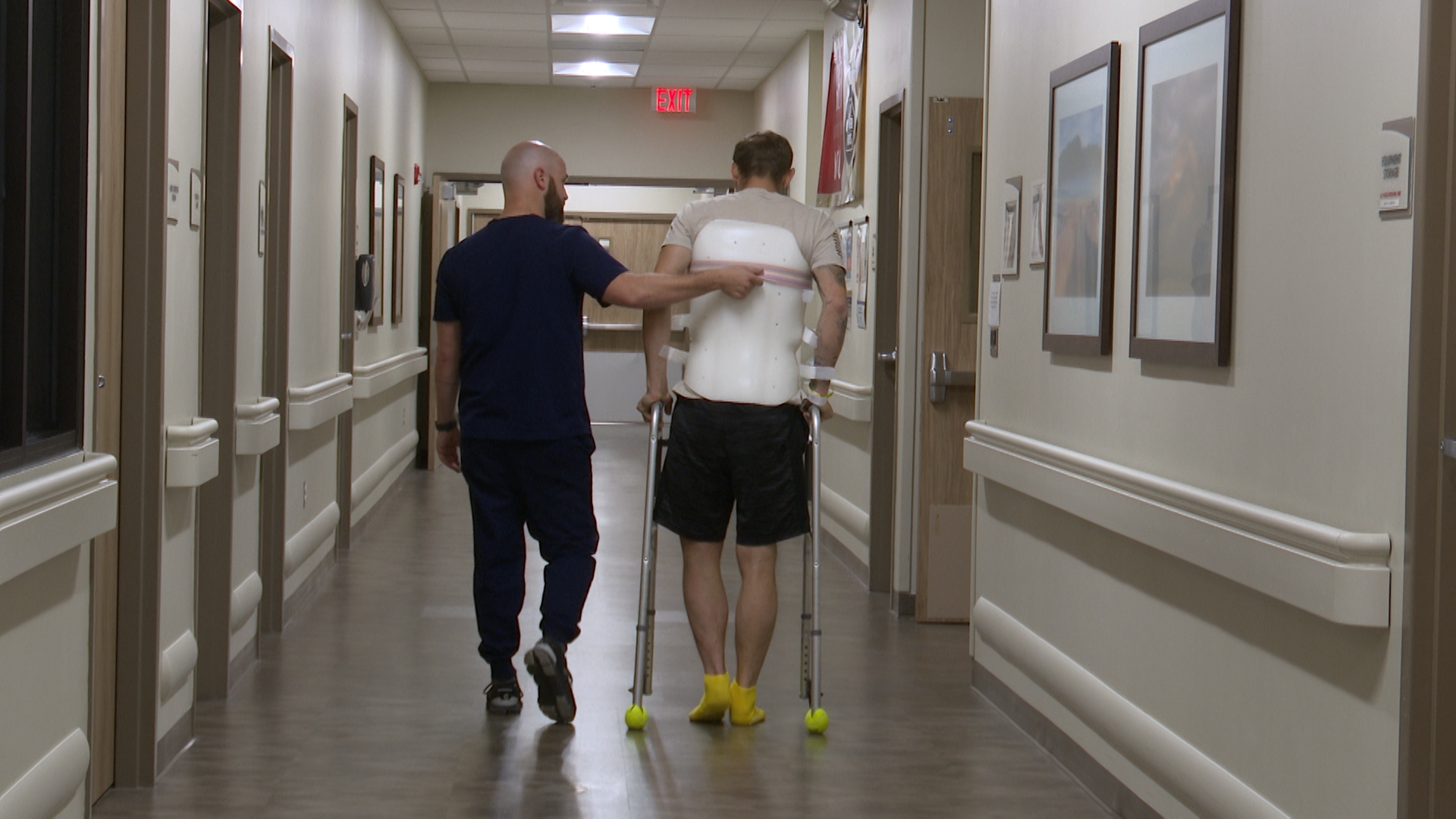 Aaron (right) walking with his OT, Josh (left)