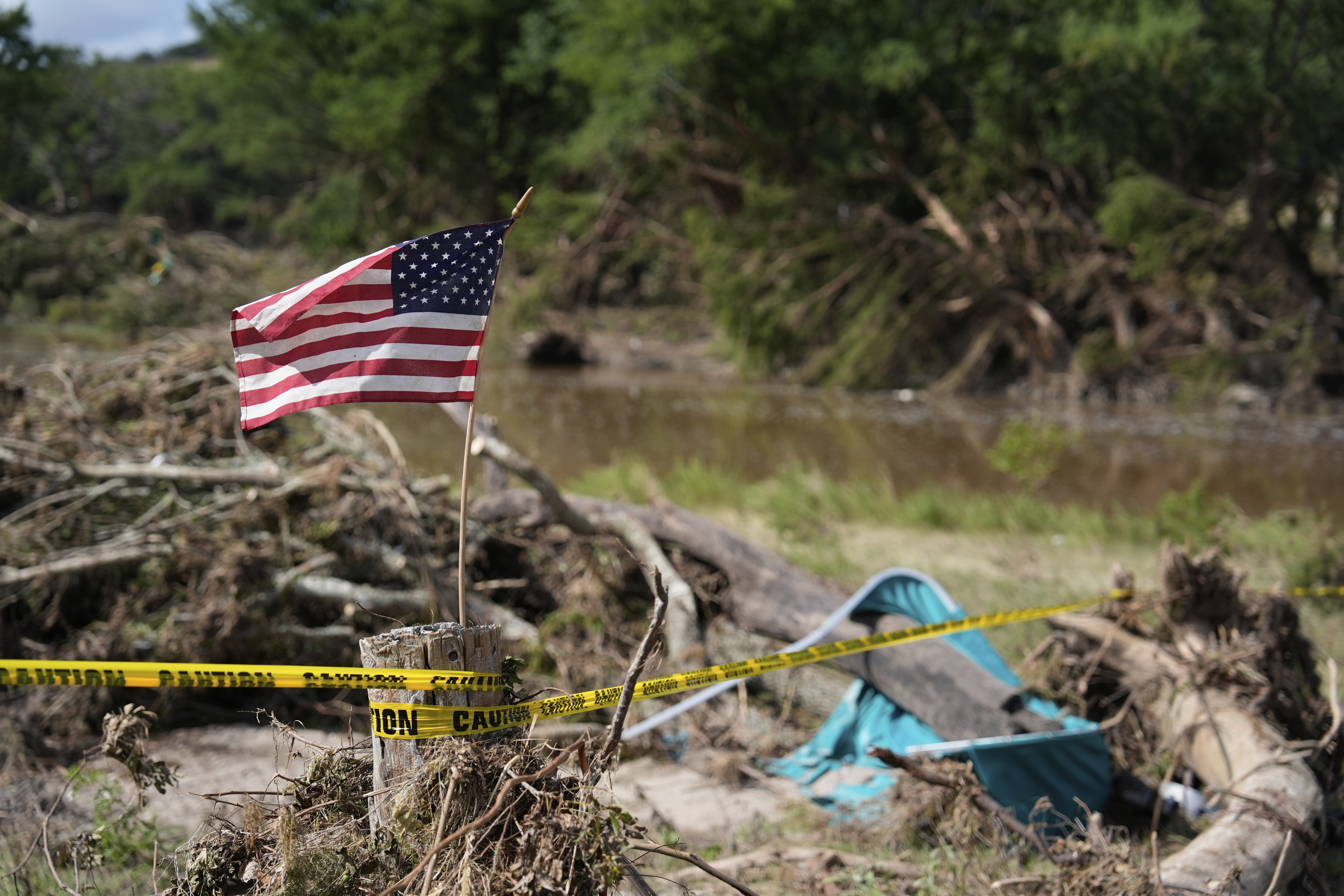 An American flag is placed on a stump flies in Kerrville, Texas on July 8, 2025. 