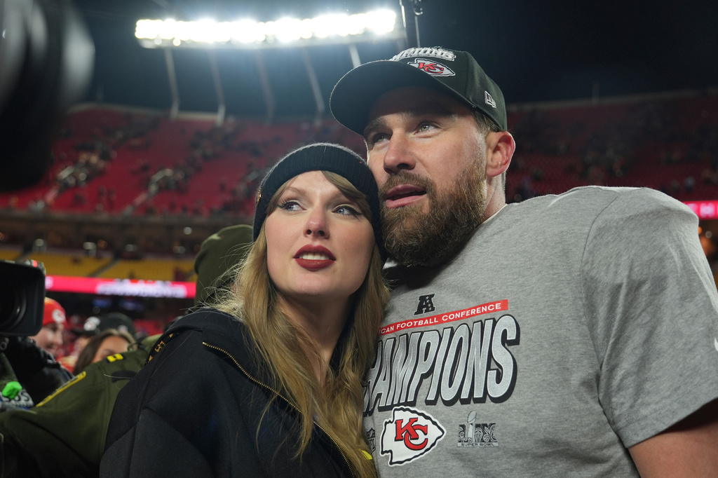 FILE - Kansas City Chiefs tight end Travis Kelce, right, is congratulated by Taylor Swift as they celebrate the Chiefs' victory over the Buffalo Bills in the AFC Championship NFL football game, Jan. 26, 2025, in Kansas City, Mo. 