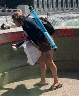 Woman accused of defacing memorial
