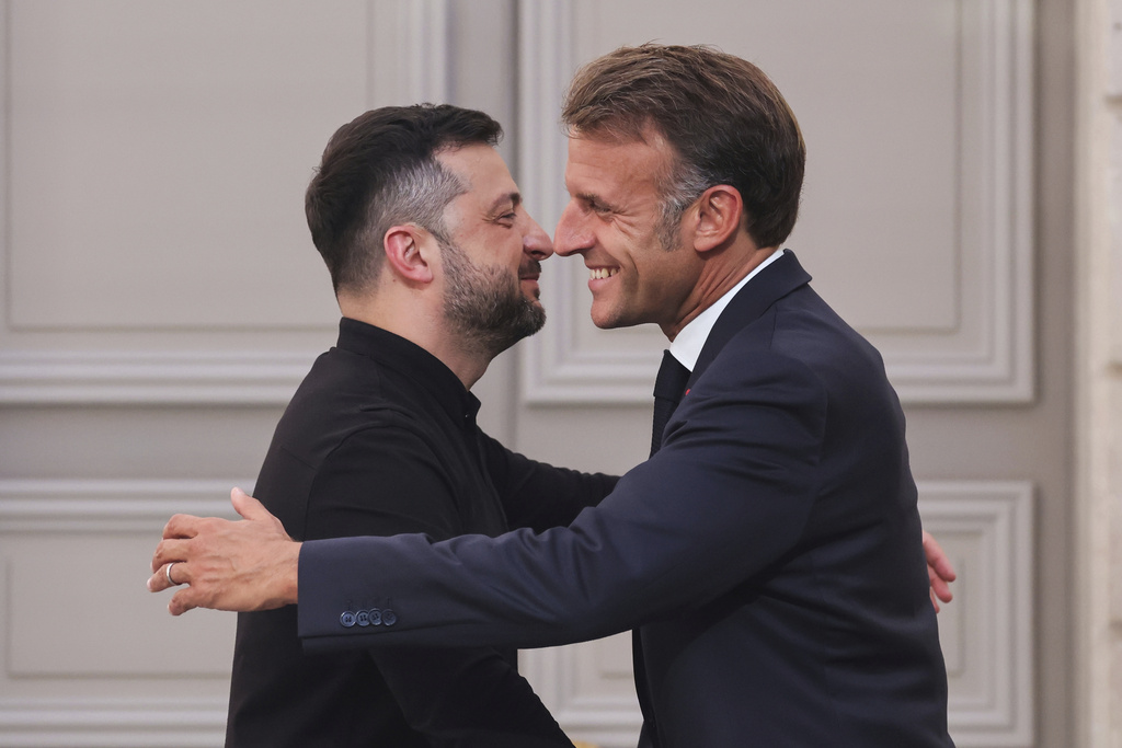 France's President Emmanuel Macron, right, embraces Ukraine's President Volodymyr Zelenskyy at the end of a press conference following a summit on Ukraine at the Elysee Palace, in Paris, France.