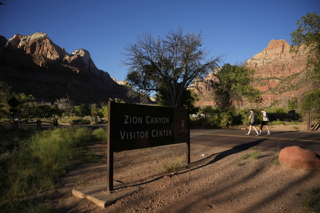 People walk near the visitor center at Zion National Park, Wednesday, Oct. 1, 2025, near Springdale, Utah.