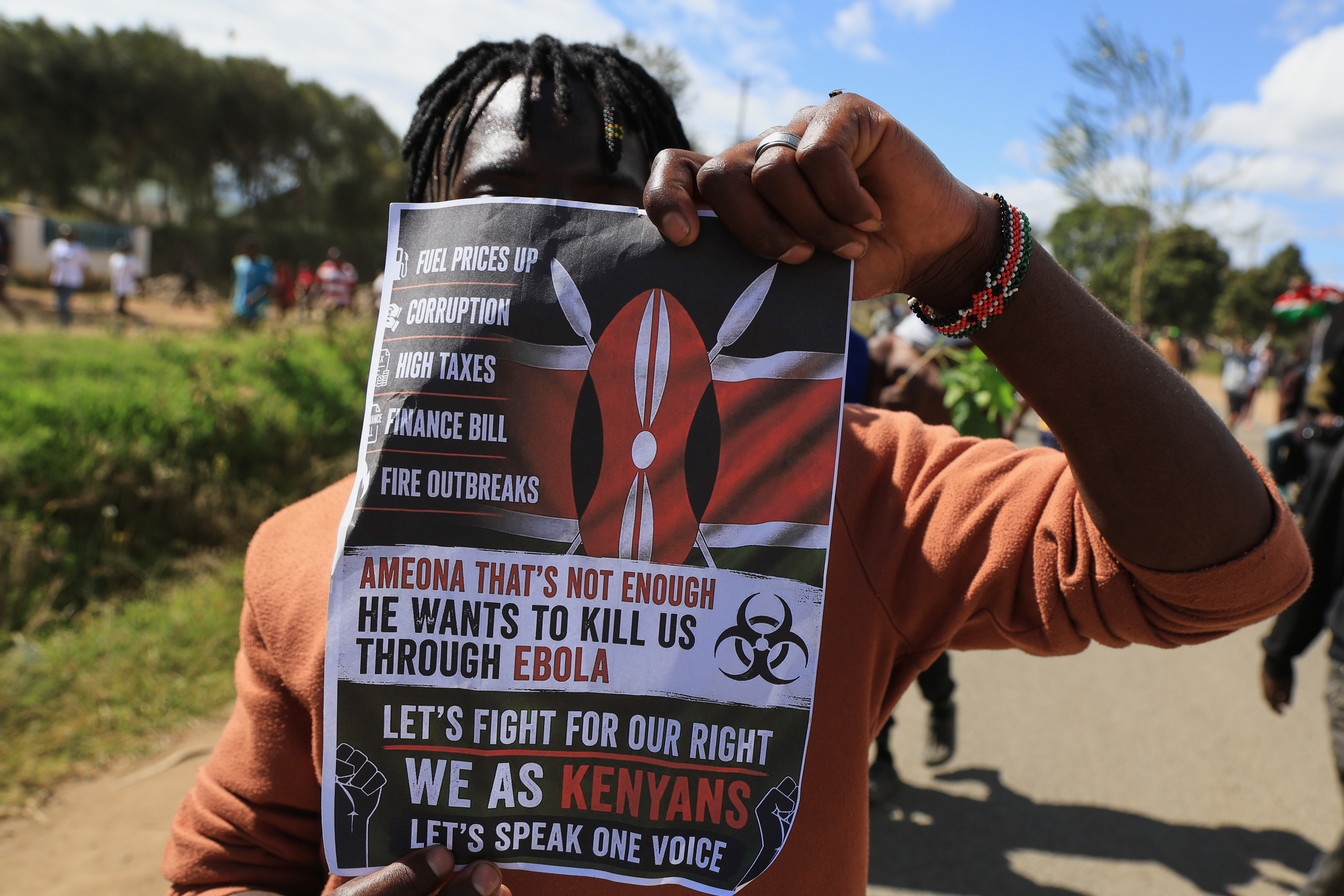 A protester holds up a placard during a demonstration against a proposed Ebola quarantine center to be established by the United States at Laikipia Air Base in Nanyuki, Kenya, Monday, June 1, 2026.