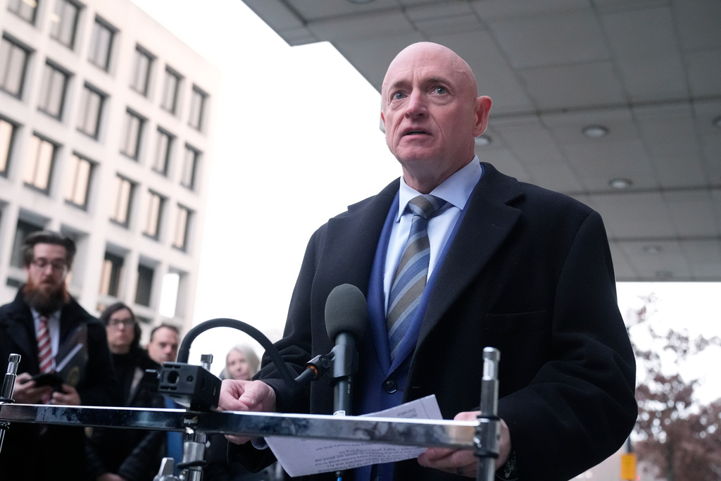 Sen. Mark Kelly, D-Ariz.,speaks to reporters outside of federal court in Washington, Tuesday, Feb. 3, 2026.