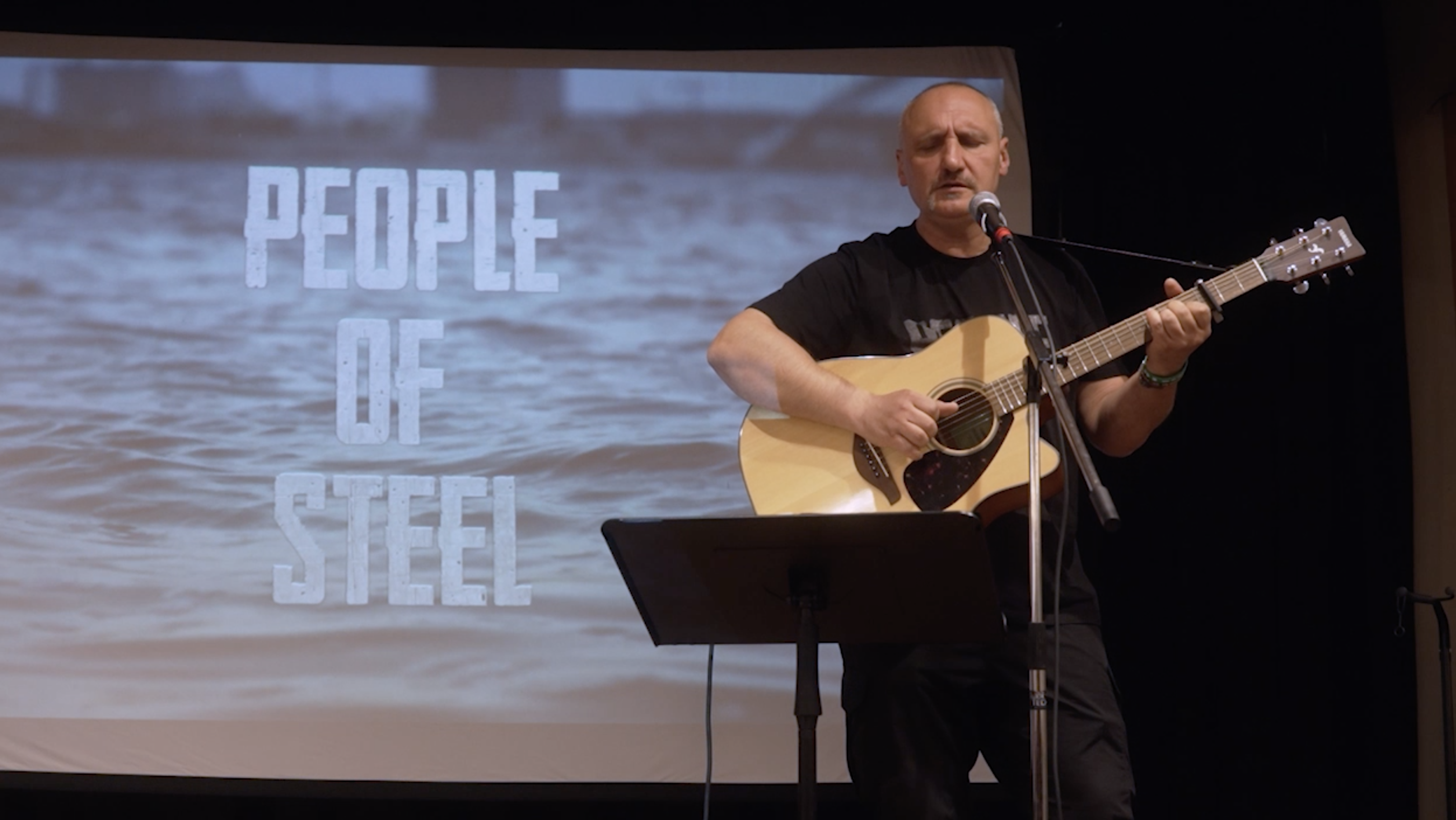 Serhiy Fomenko plays the guitar before the premiere of his documentary People of Steel. 