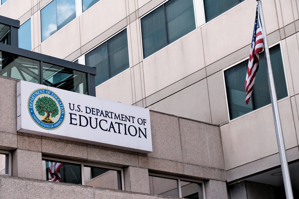 The exterior sign and US flag in front of the U.S. Department of Education offices in Washington, DC.
