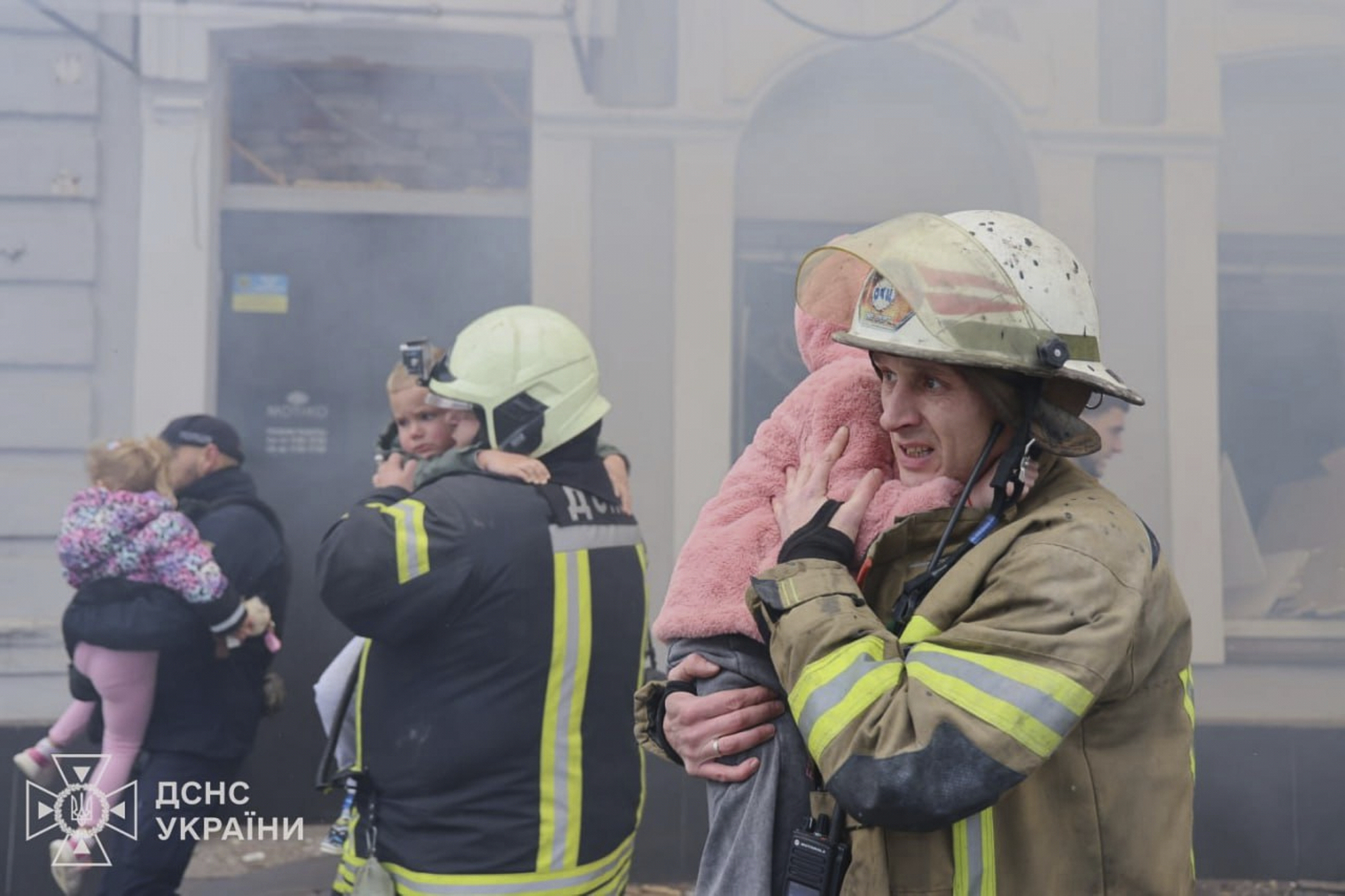 In this photo provided by the Ukrainian Emergency Service, rescuers evacuate children after Russian drones hit a city kindergarten during an attack in Kharkiv, Ukraine, Wednesday, Oct. 22, 2025.