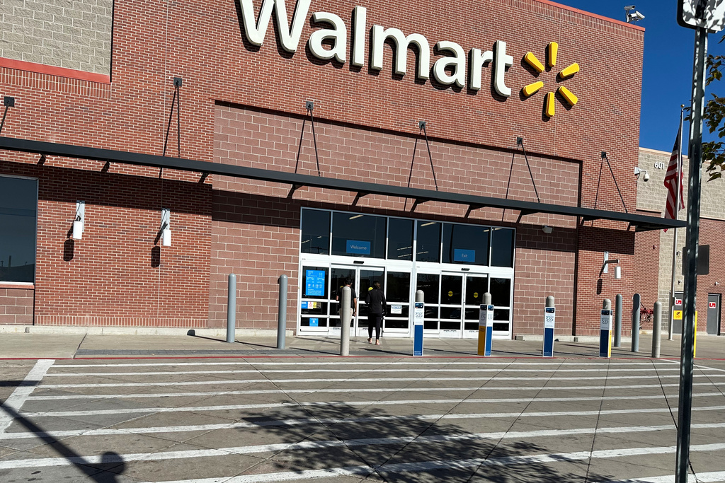 A shopper heads into a Walmart store.