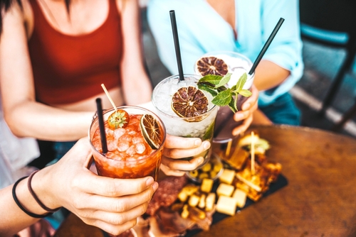 Stock image of people holding cocktails.