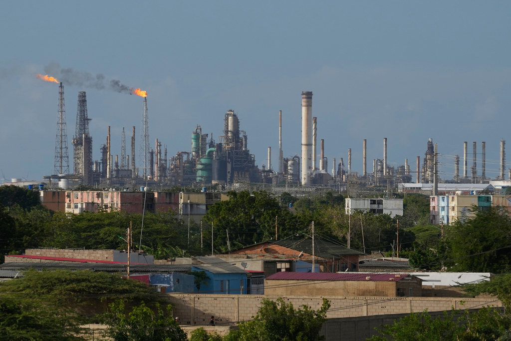 Flames rise from flare stacks at the Amuay refinery in Los Taques, Venezuela, Wednesday, Jan. 14, 2026. 