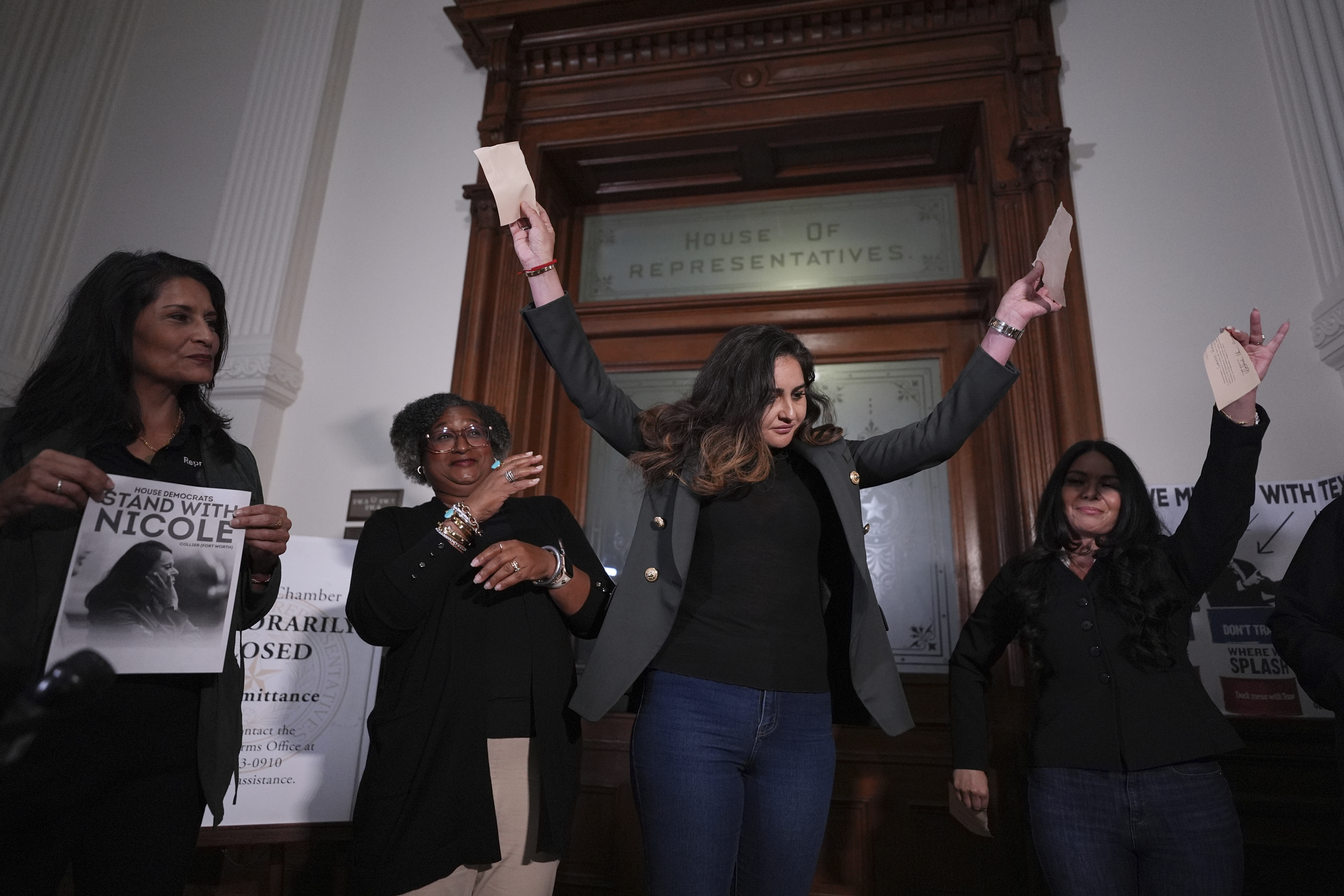 Democratic Texas state Rep. Mihaela Plesa, center, and Rep. Cassandra Garcia Hernandez, right, tear up their 'permission slips' outside of the House Chamber as they plan to join fellow Rep. Nicole Collier who refuses to leave due to a required law enforcement escort, Tuesday, Aug. 19, 2025, in Austin, Texas. 