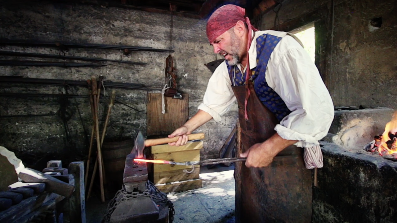 Man hammering a piece of hot metal.