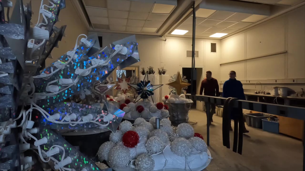 Ben Sabol of Savant and News 5 reporter Michelle Jarboe walk through the GE Lighting holiday warehouse at Nela Park.