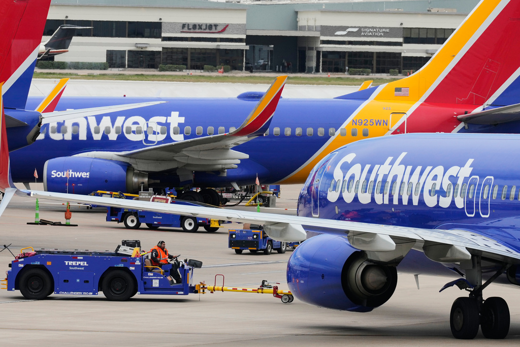 Flight line workers push a Southwest Airlines aircraft away from a gate at Love Field Airport in Dallas, Monday, March 16, 2026. 