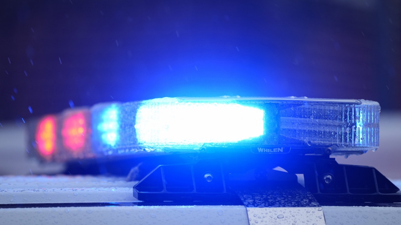 Lights on a parked police vehicle flash.