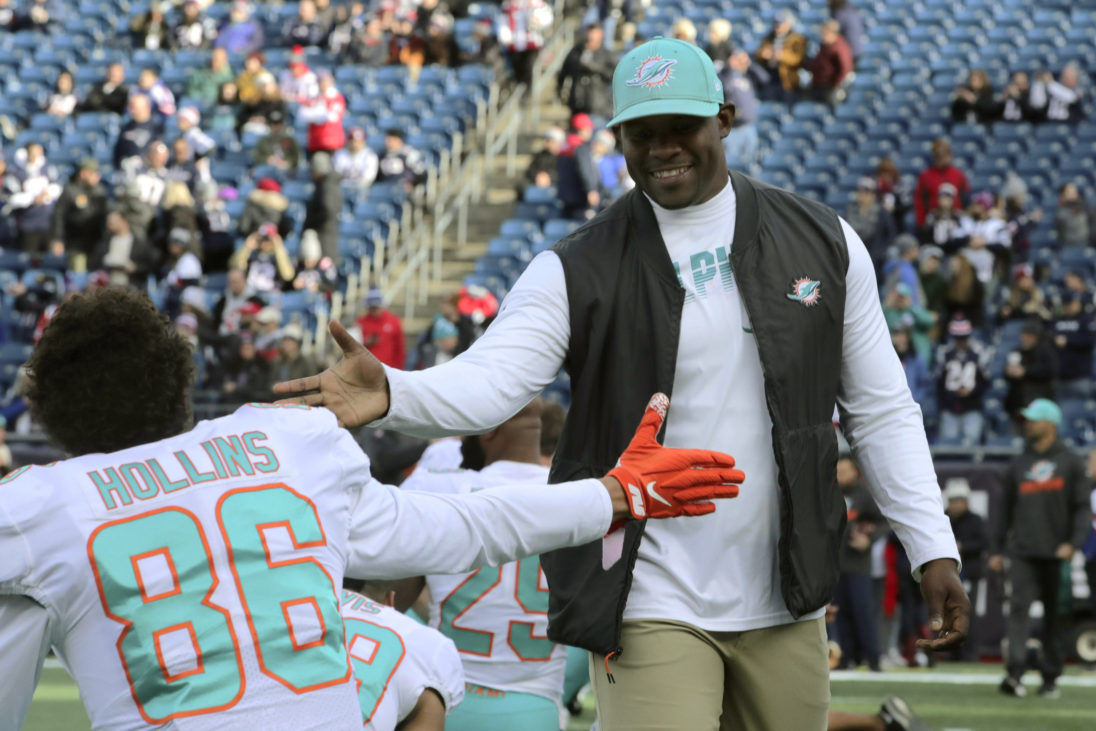 Miami Dolphins head coach Brian Flores slaps hands with wide receiver Mack Hollins, December 2019