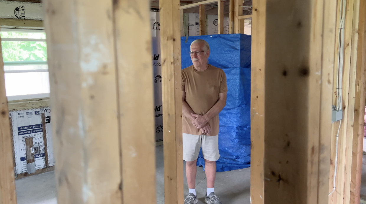 Reggie Chapman stands in skeleton of home.png