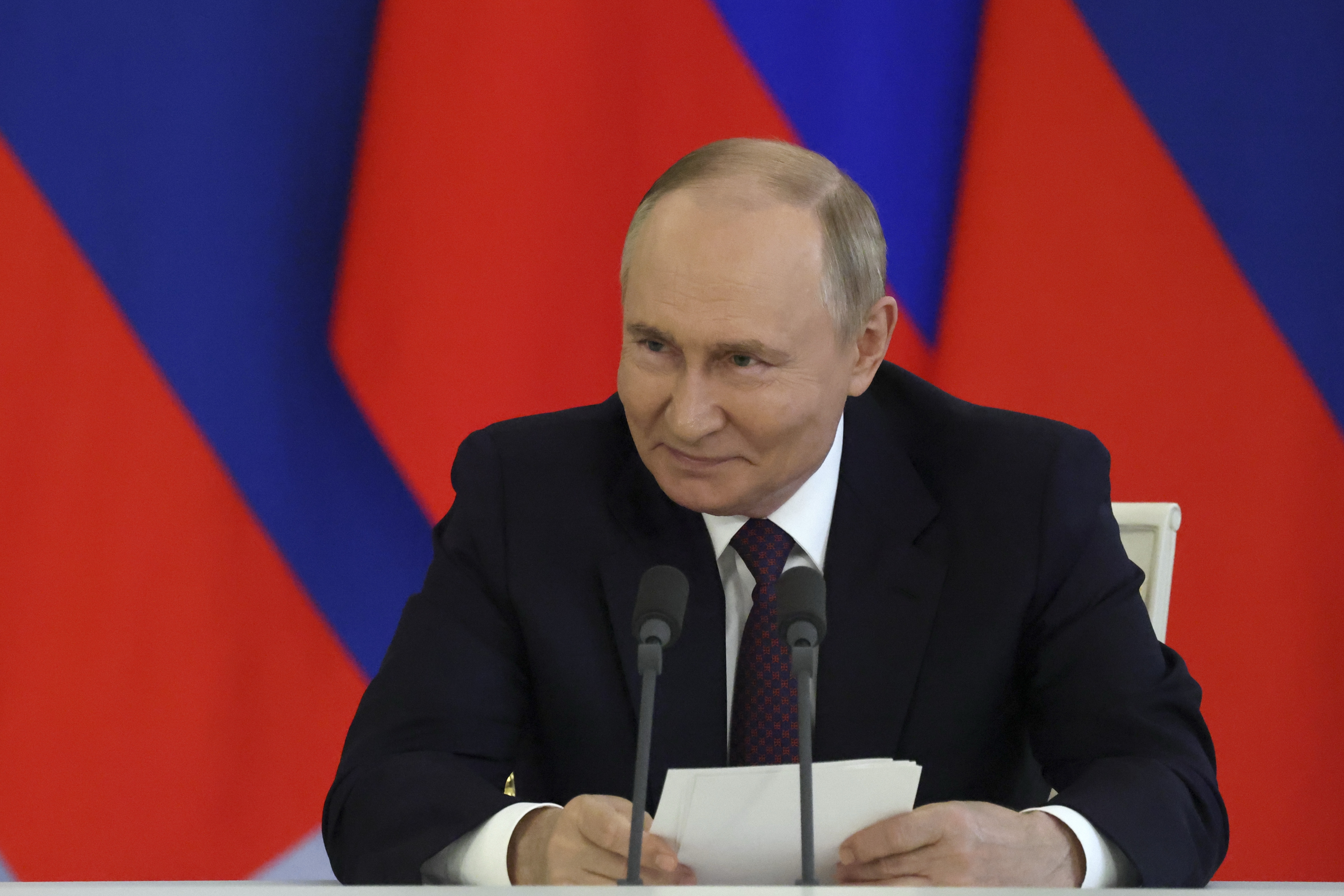Russian President Vladimir Putin speaks after a ceremony of exchange of documents following his meeting with Laotian President Thongloun Sisoulith.