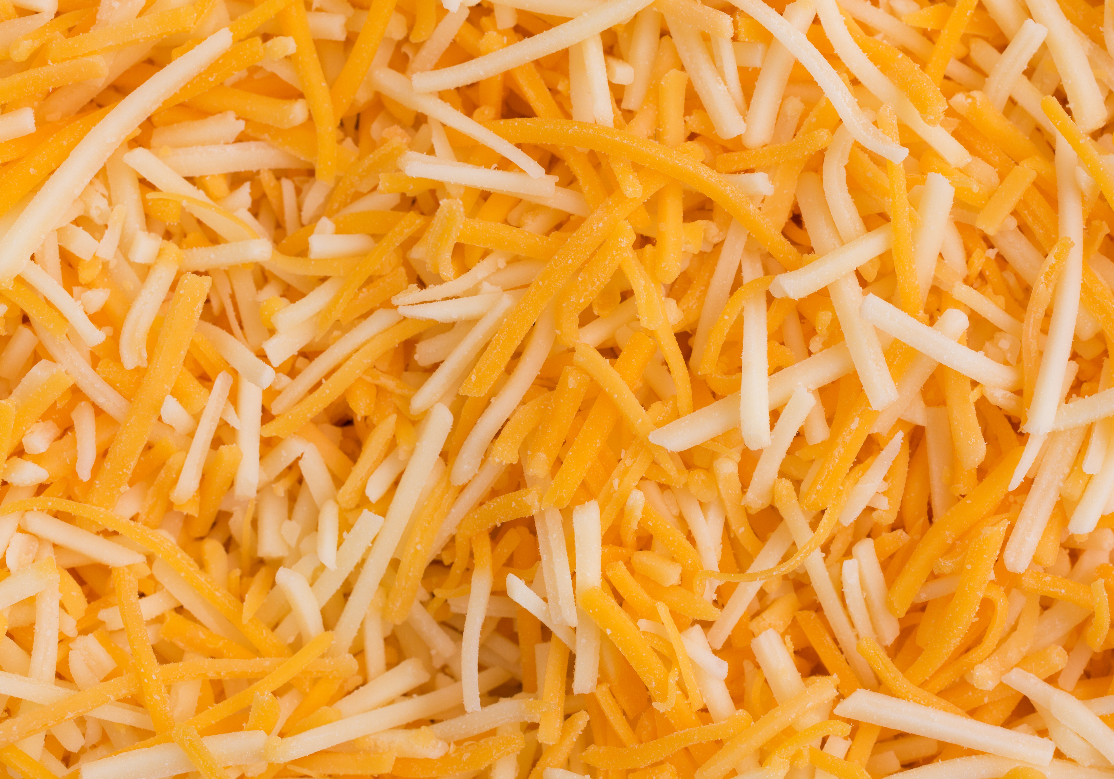 Shredded white and orange cheddar cheese.