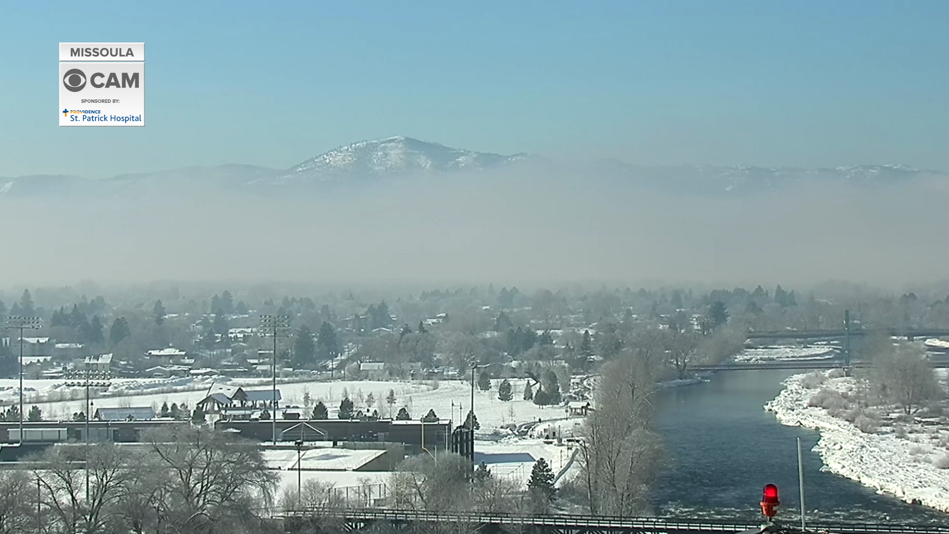 Blue skies appear above fog