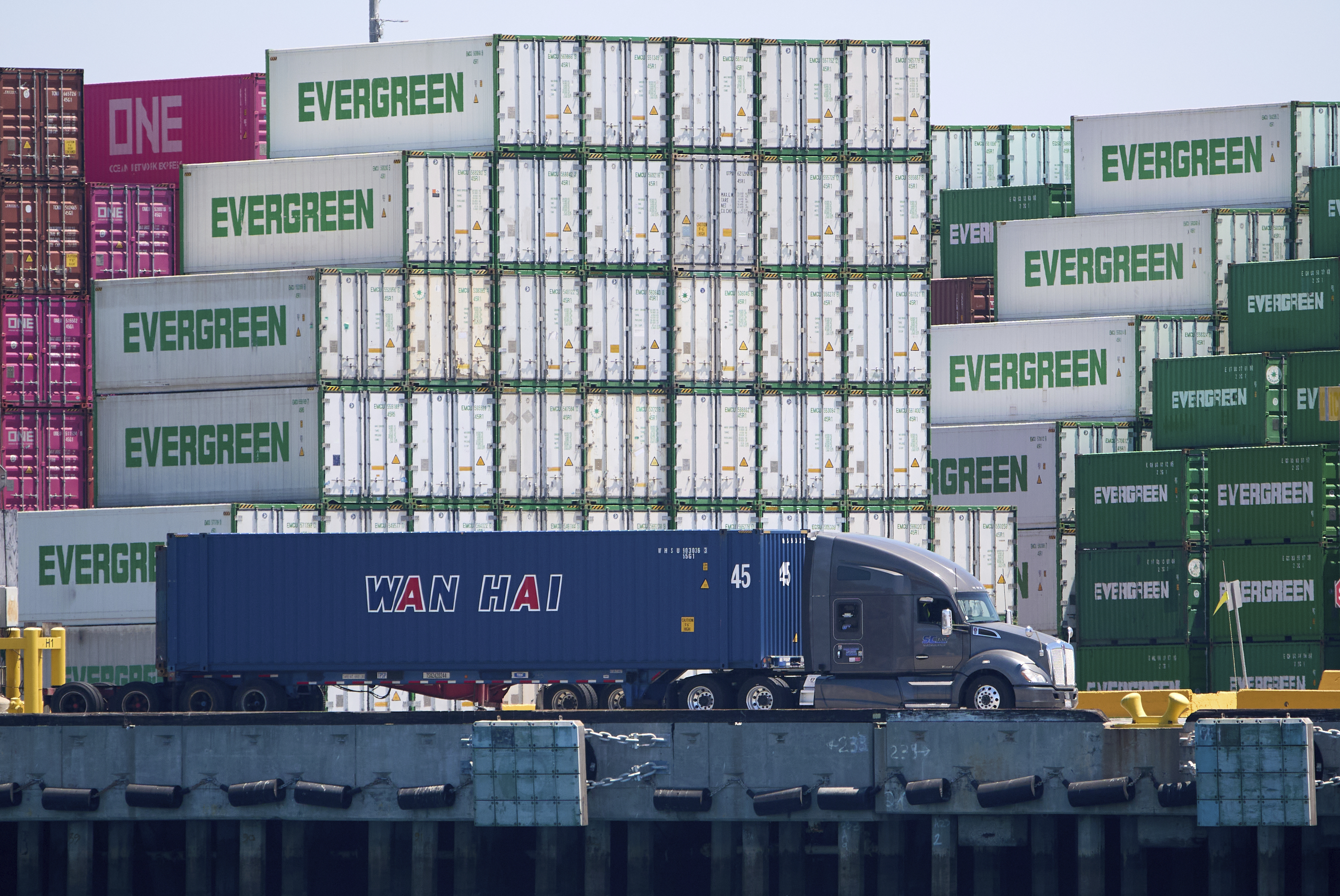Shipping containers are processed at the Evergreen terminal at the Port of Los Angeles, on Friday, Aug. 1, 2025. 