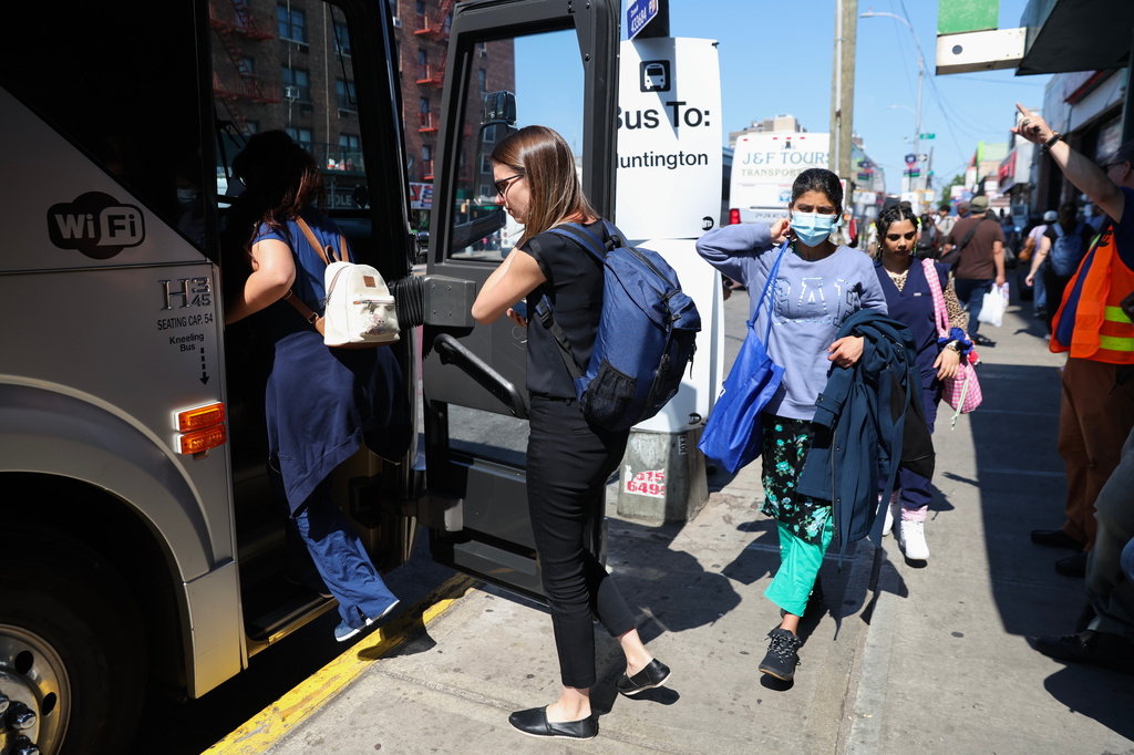 Commuters board buses to Long Island outside of the Jamaica–179th Street station as Long Island Rail Road workers enter the third day of their strike, Monday, May 18, 2026, in New York. 