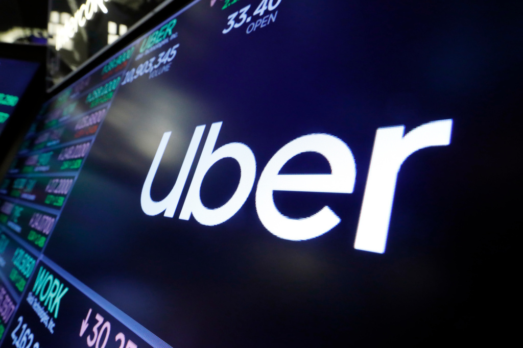 The Uber logo appears above a trading post on the floor of the New York Stock Exchange, Aug. 16, 2019. 