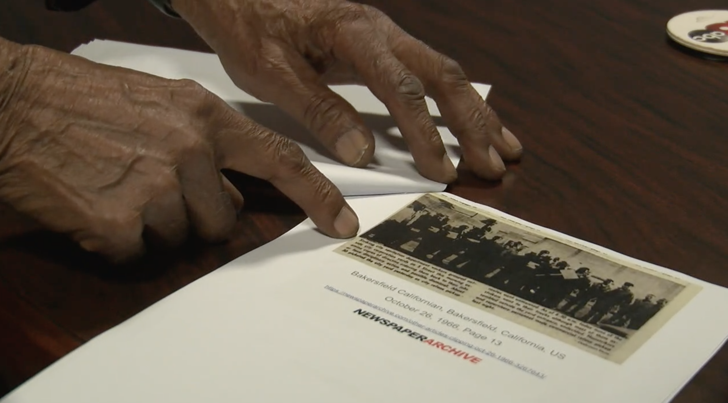 James Mason looking at coverage of the sanitation workers strike of 1966