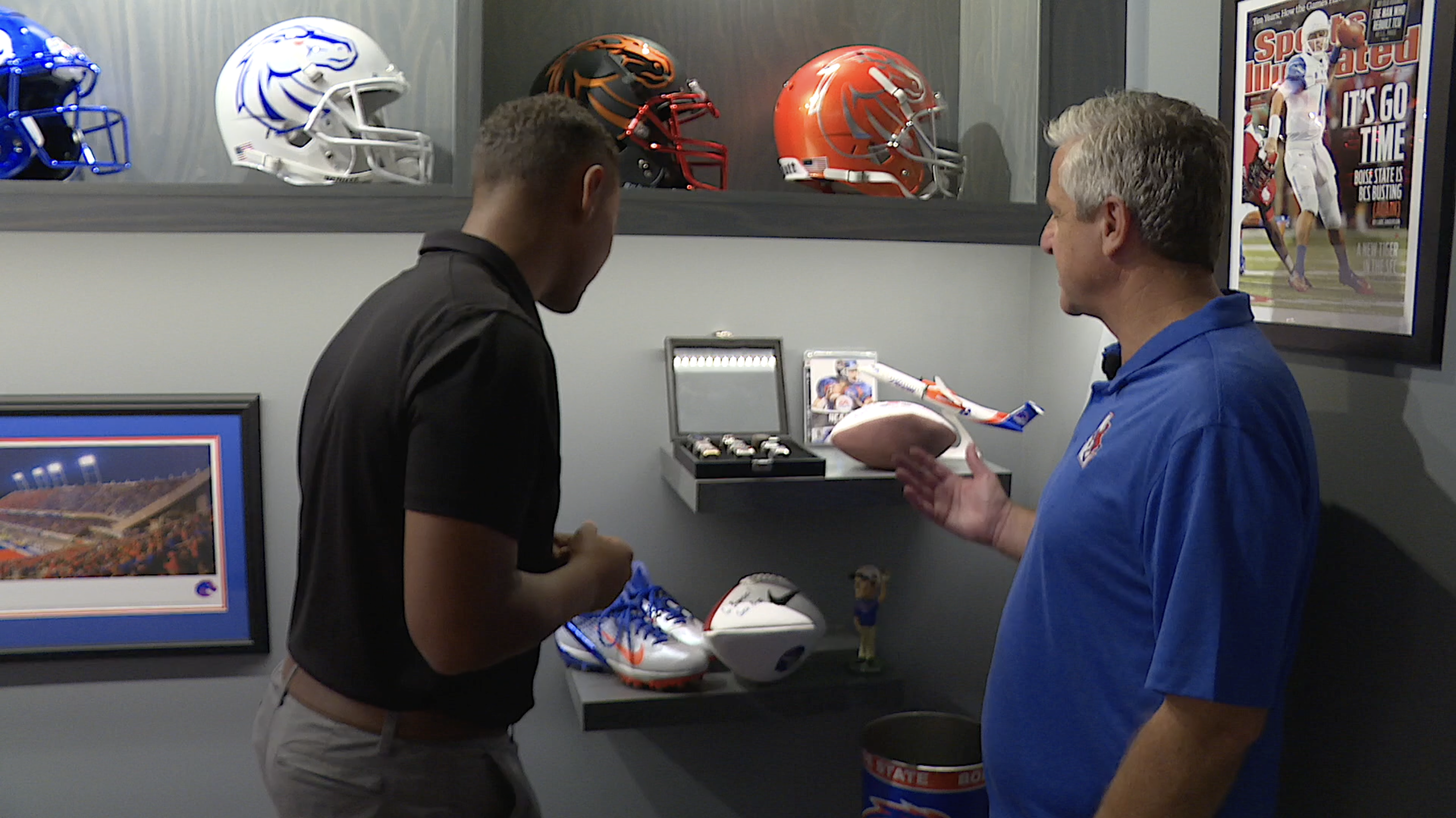 Travis Hawkes shows Idaho News 6 reporter, Brendyn Jones, his Boise State memorabilia collection