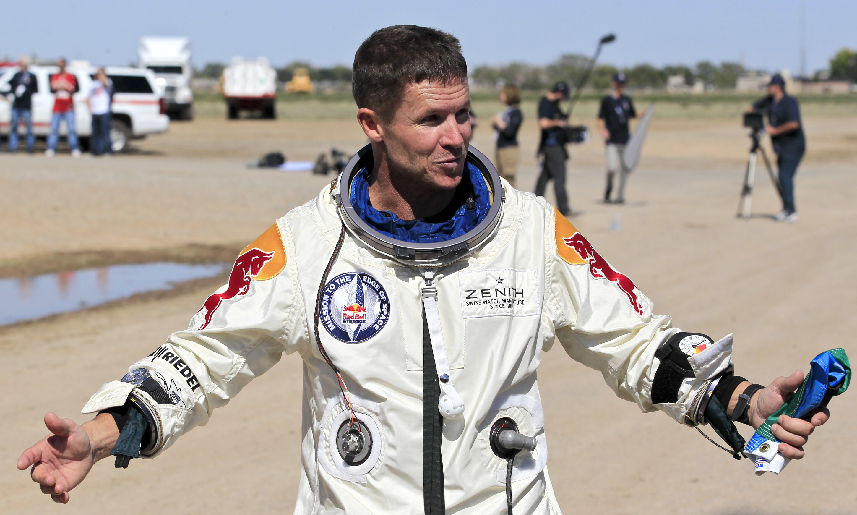 Felix Baumgartner of Austria gestures prior to speaking with the media after successfully jumping from a space capsule lifted by a helium balloon in Roswell, N.M., Oct. 14, 2012.