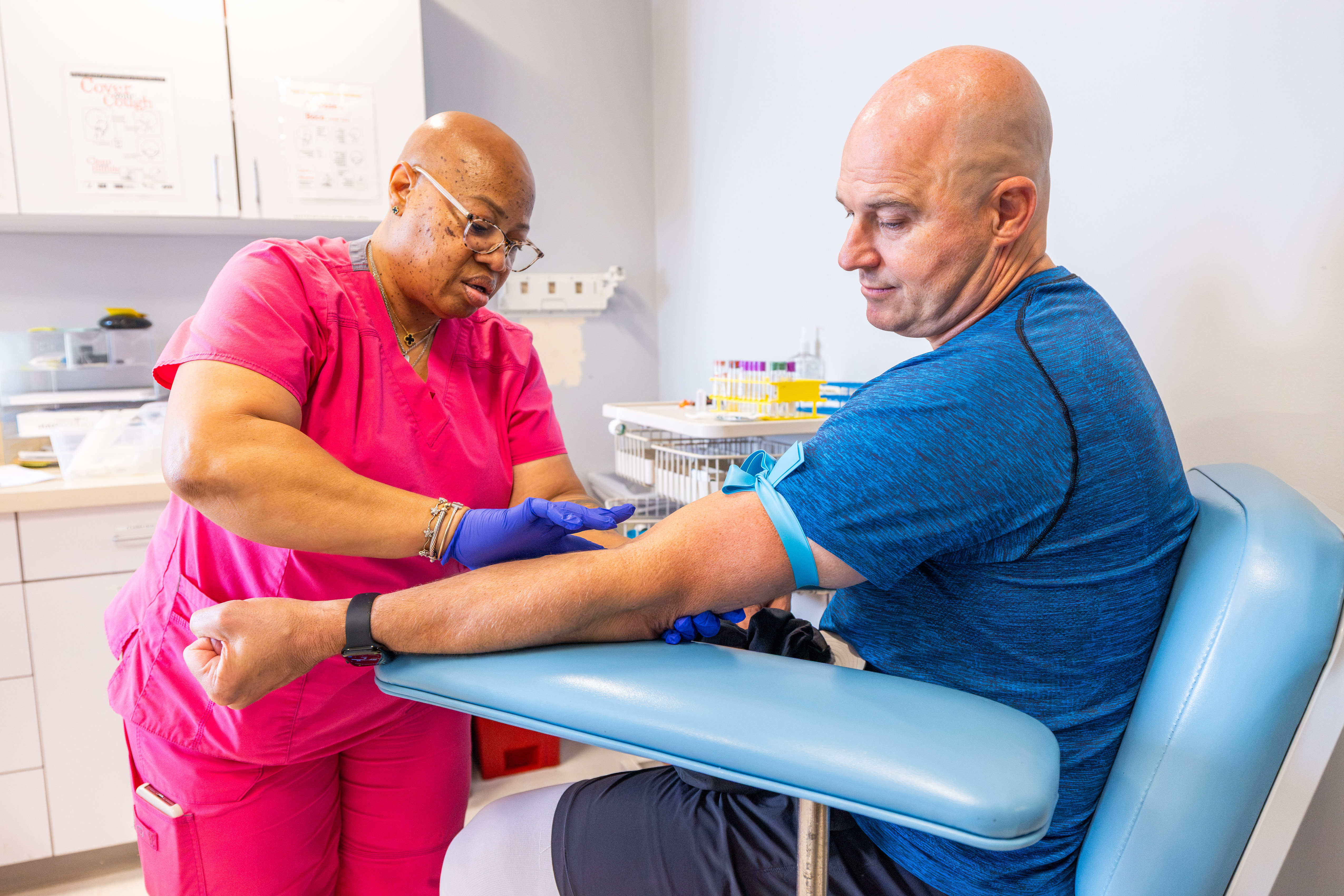 Former NFL quarterback Matt Hasselbeck, right, has his blood drawn during medical tests on July 28, 2026, at Boston University, in Boston.